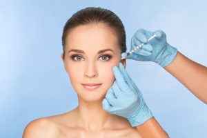 Beauty woman giving botox injections.